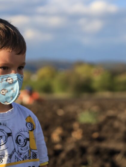 boy in white and blue crew neck shirt with white and blue pacifier