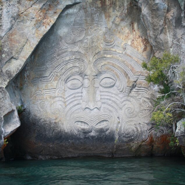 body of water between gray rock formation during daytime